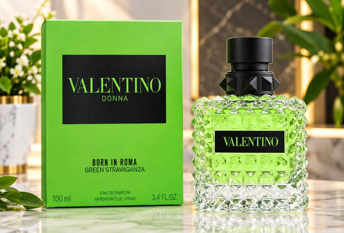Valentino Donna Green Stravaganza perfume bottle and its green packaging box, displayed on a marble surface with decorative plants in the background.